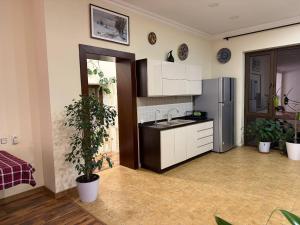 a kitchen with a sink and a refrigerator at Просторный дом с садом in Qŭyliq