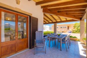 a patio with a table and chairs on it at Can Fusteret in Son Serra de Marina