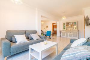 a living room with a couch and a table at Can Fusteret in Son Serra de Marina