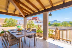 a table and chairs on a patio with a view at Can Fusteret in Son Serra de Marina