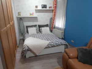 a small bedroom with a bed with pillows at Spacious House in Tongeren in Tongeren