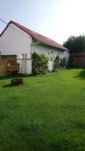 a white house with a yard with green grass at Spacious House in Tongeren in Tongeren