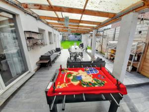 a ping pong table in the middle of a patio at Spacious House in Tongeren in Tongeren