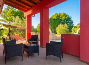 a patio with chairs and a table with a view at Charming Villa in Noto with Private Pool in Noto