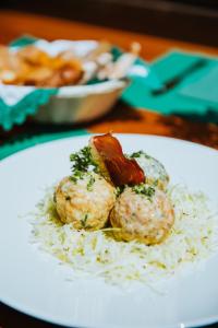 a plate of food with meatballs and rice on a table at Ütia De Börz in San Martino in Badia
