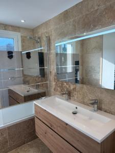 a bathroom with a sink and a mirror at Premium Apartment with Private Jacuzzi in Mougins +14 photos