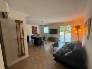 a living room with a couch and a table at Premium Apartment with Private Jacuzzi in Mougins