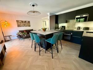 a kitchen and living room with a table and chairs at Premium Apartment with Private Jacuzzi in Mougins