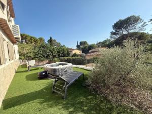 a bench sitting on the grass in a yard at Premium Apartment with Private Jacuzzi in Mougins