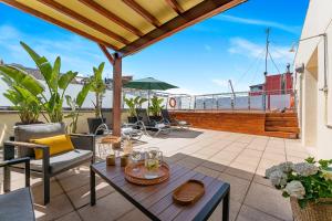 a patio with a table and chairs on a balcony at Acacia Suite in Barcelona