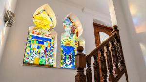 a stained glass window on a wall next to a staircase at Sea-View Villa with Infinity Pool Algiers in Tipaza