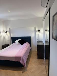 a bedroom with a bed and two night stands at Premium Apartment with Private Jacuzzi in Mougins
