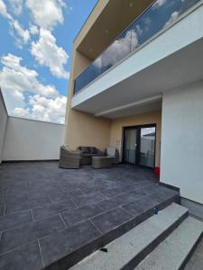 a large patio with couches on the side of a building at Vila Lux Braila in Brăila