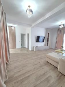 a large living room with a couch and a television at Vila Lux Braila in Brăila