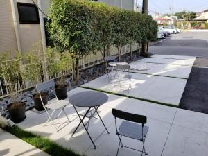 a group of chairs and tables on a sidewalk at Tsukuba Daily Inn in Tsukuba