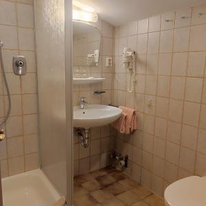 a bathroom with a sink and a shower at Pretzners Ferienwohnungen in Reit im Winkl +23 photos