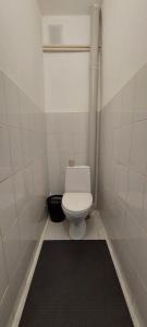 a bathroom with a toilet and a black rug at Арай 2 - 116 in Qyzylorda