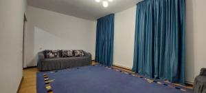 a living room with a couch and a blue rug at Арай 2 - 116 in Qyzylorda