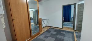 a room with a hallway with a mirror and a door at Арай 2 - 116 in Qyzylorda