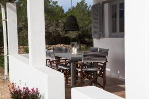 a table and chairs sitting on a patio at Comfortable House in Formentera with Garden and Terrace in Sant Francesc Xavier