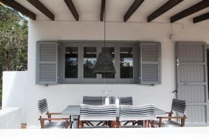 a dining table and chairs on a patio at Comfortable House in Formentera with Garden and Terrace in Sant Francesc Xavier