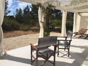 two chairs and a table on a patio at Comfortable House in Formentera with Garden and Terrace in Sant Francesc Xavier