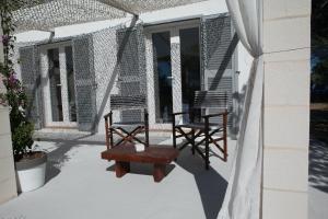 two chairs and a table on a porch at Comfortable House in Formentera with Garden and Terrace in Sant Francesc Xavier +24 photos