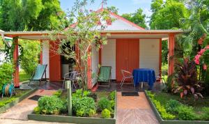 a house with a table and chairs in front of it at Charming Studio in Foulpointe, Sea View and Garden, 30 m² in Foulpointe