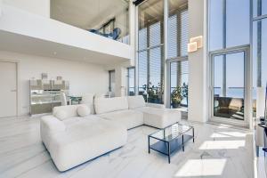 a living room with a white couch and a glass table at Penthouse With The Best Views! in Barcelona