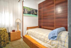 a bedroom with a bed with a wooden headboard at Charming Villa in Vitigudino with Private Pool in Vitigudino