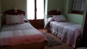 a bedroom with two beds with pink and white sheets at Charming Chalet in Viella, Mountain View in Vielha