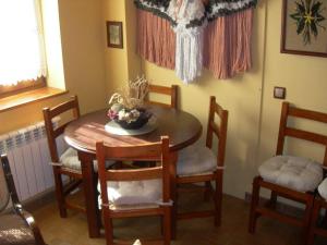 a dining room table with chairs and a bowl of flowers on it at Charming Chalet in Viella, Mountain View in Vielha +19 photos