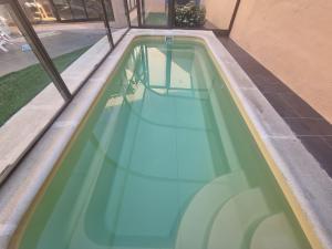 a pool of blue water on the side of a building at Charming villa in Pajares de la Lampreana with private pool in Pajares de la Lampreana
