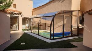 a swimming pool in a glass house with a playground at Charming villa in Pajares de la Lampreana with private pool in Pajares de la Lampreana