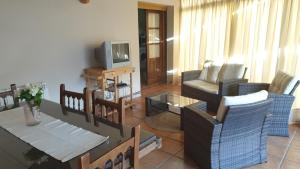 a living room with two chairs and a tv at Charming villa in Pajares de la Lampreana with private pool in Pajares de la Lampreana +11 photos