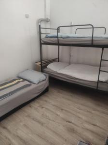 two bunk beds in a room with a wooden floor at Station Backpackers in Budapest
