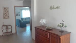 a living room with a dresser and a blue couch at Spacious house in Aldeia dos Pinheiros with pool in Azeitao