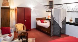 a small room with a bed and a couch at Studio confortable à Thilouze de 55 m² avec jardin privatif in Thilouze +4 photos