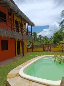 a swimming pool in front of a house at Flatmoitas in Amontada