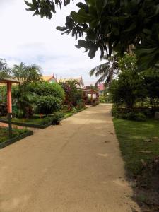 a walkway in a park with trees and plants at Comfortable Studio with Sea View in Foulpointe - 30 m² in Foulpointe