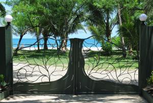 a gate to the beach with a dress on it at Comfortable Studio with Sea View in Foulpointe - 30 m² in Foulpointe