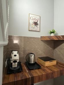 a counter with a coffee maker and a coffee pot on it at Bed and Breakfast Medaglia D'oro in Marcianise