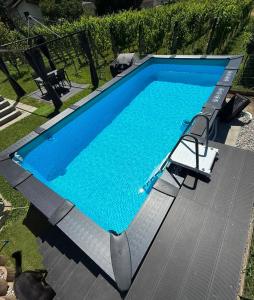 a swimming pool with two chairs next to it at Casa Home-Art in Biasca