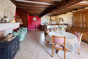 a kitchen with a table with chairs and a stove at Chez Pauline in Massangis +11 photos