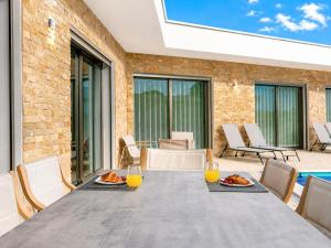 a dining table with two plates of food on a patio at Villa Flamingo - BY SCH in Nadadouro