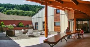 two people sitting at a table on a patio at Appartement cosy à Fayet avec vue in Fayet +5 photos