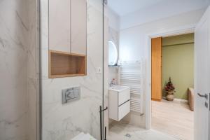 a white bathroom with a shower and a sink at Own the Moment by Blvd 41B7 - Free Parking in Voluntari