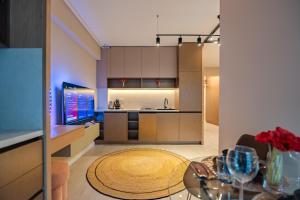 a kitchen and living room with a glass table at Own the Moment by Blvd 41B7 - Free Parking in Voluntari