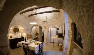 a kitchen and a dining room with a table and chairs at Spacious Villa with Private Pool in Castellana Grotte in Alberobello