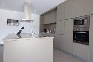 a kitchen with a white counter top and appliances at Luxurious Villa in Vieira do Minho – Private Pool in Vieira do Minho